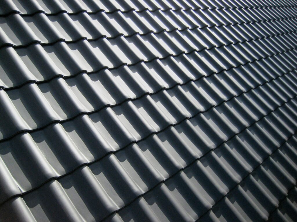 Dark grey roof tiles casting sharp shadows, the first line of defence against water getting in