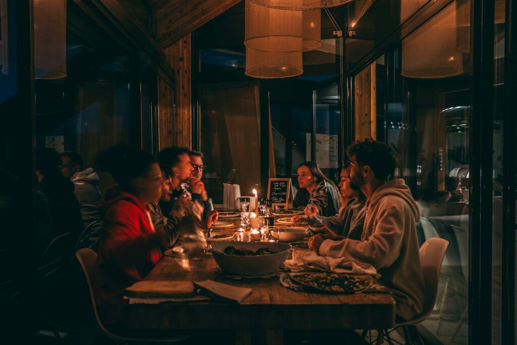 People enjoying a candlelit dinner in a dimly lit restaurant, the dining experience customers look for