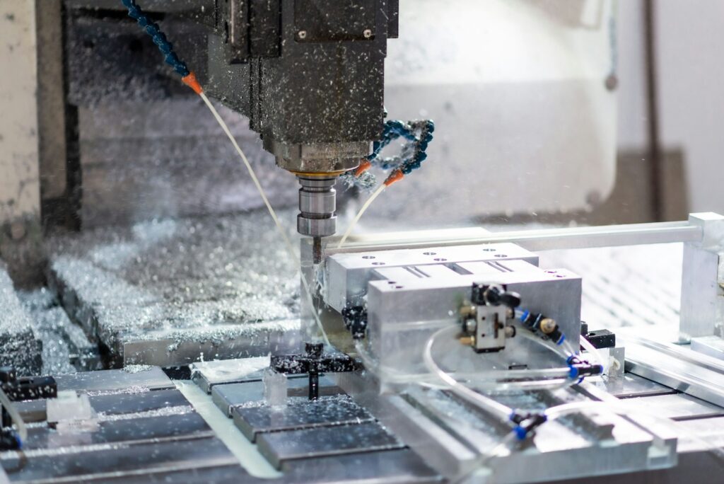 A CNC machine milling a piece of aluminium, the kind of machining used for threaded holes